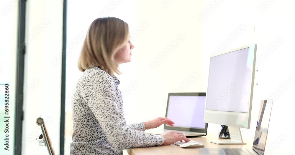 Business woman performing multitasking work on electronic devices ...