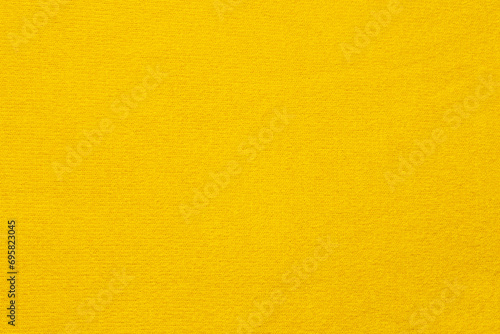 Texture of a delicate yellow terry towel