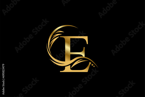 Gold letter E logo design with beautiful leaf, flower and feather ornaments. initial letter E. monogram E flourish. suitable for logos for boutiques, businesses, companies, beauty, offices, spas, etc