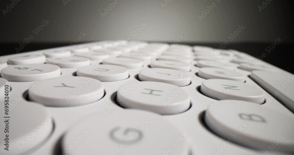 Modern white computer keyboard on a black background. Profession of IT specialists Modern white computer keyboard on a black background. Profession of IT specialists
