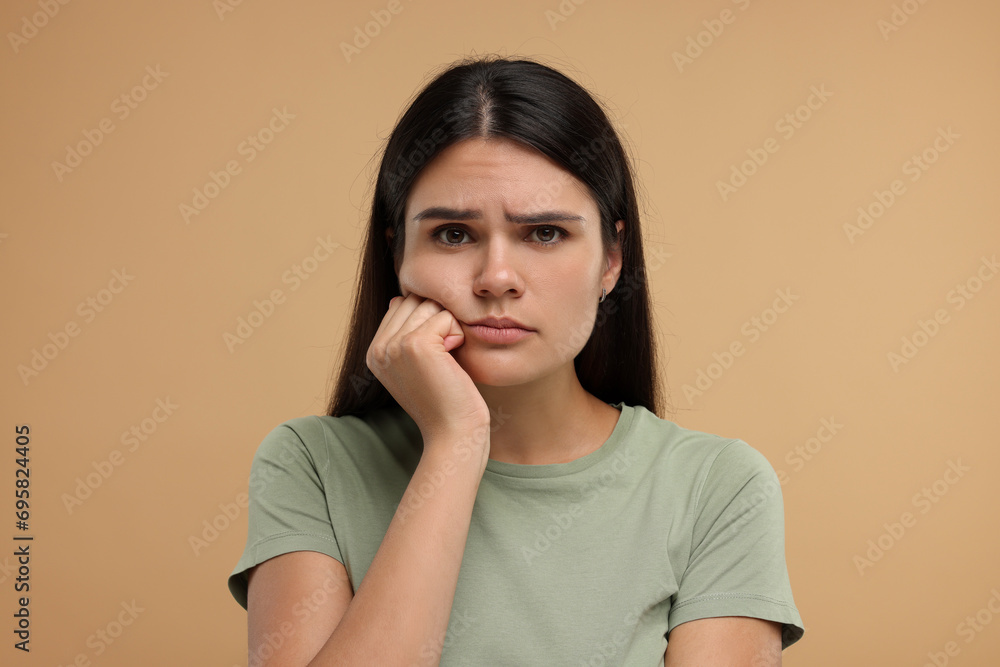 Portrait of resentful woman on beige background Portrait of resentful woman on beige background