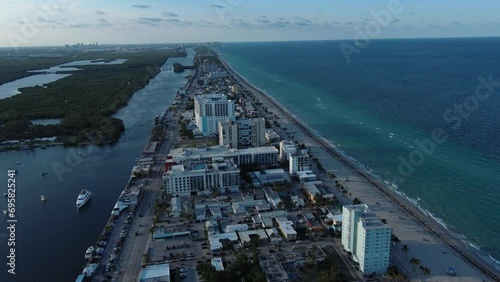 Flight over the roofs of houses, road, bridge, sea, cars, Hollywood, Miami. Filming from a drone.