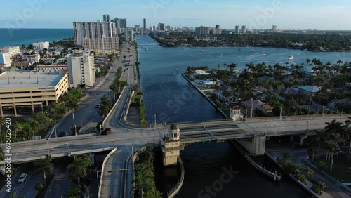 Flight over the roofs of houses, road, bridge, sea, cars, Hollywood, Miami. Filming from a drone.