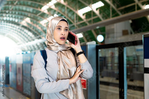 Asian muslim woman on subway train transit system public. Public transport concept photo