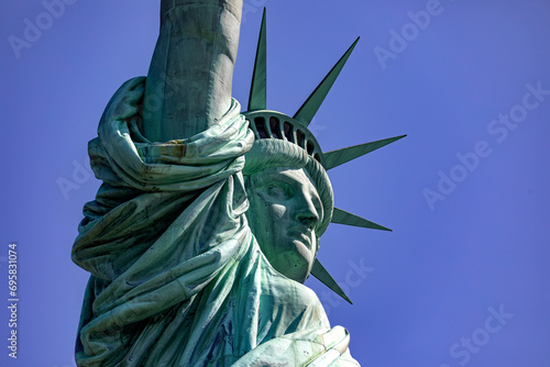 Photo of the Statue of Liberty, holding her huge torch in the Big Apple, a monument known as the lady of New York, a world famous landmark.