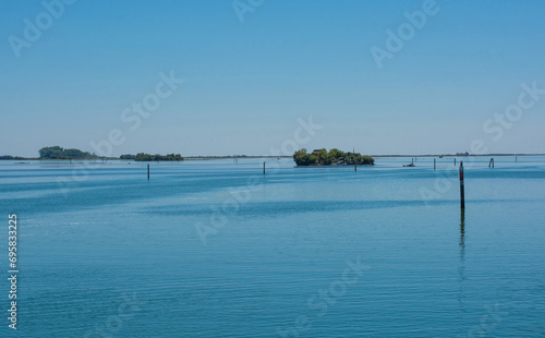 Markers show the edge of a navigable channel in the shallow waters in the Grado section of the Marano and Grado Lagoon in Friuli-Venezia Giulia  north east Italy. August