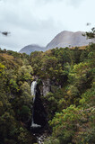 Waterfall in Scottish `highlands with mountain in background