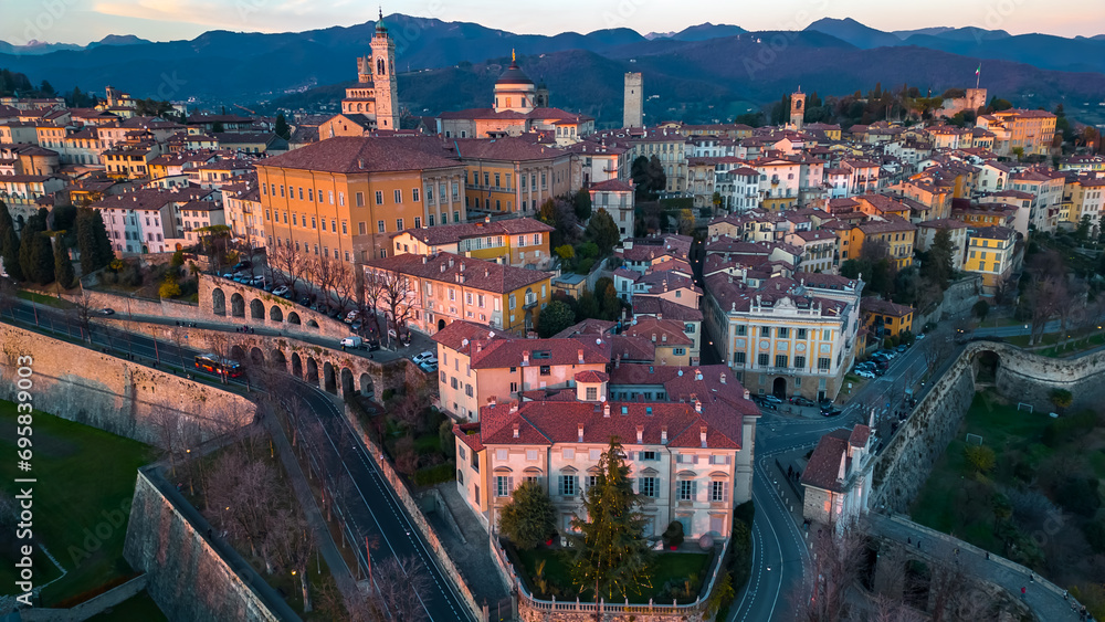 Citta Alta - Bergamo, Italy. Drone aerial view of the old town during sunrise. Landscape at the city center, its historical buildings.