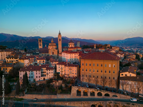 Citta Alta - Bergamo, Italy. Drone aerial view of the old town during sunrise. Landscape at the city center, its historical buildings.