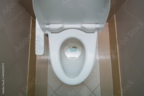 High Tech toilet with automatic bidet installed in public restroom photo