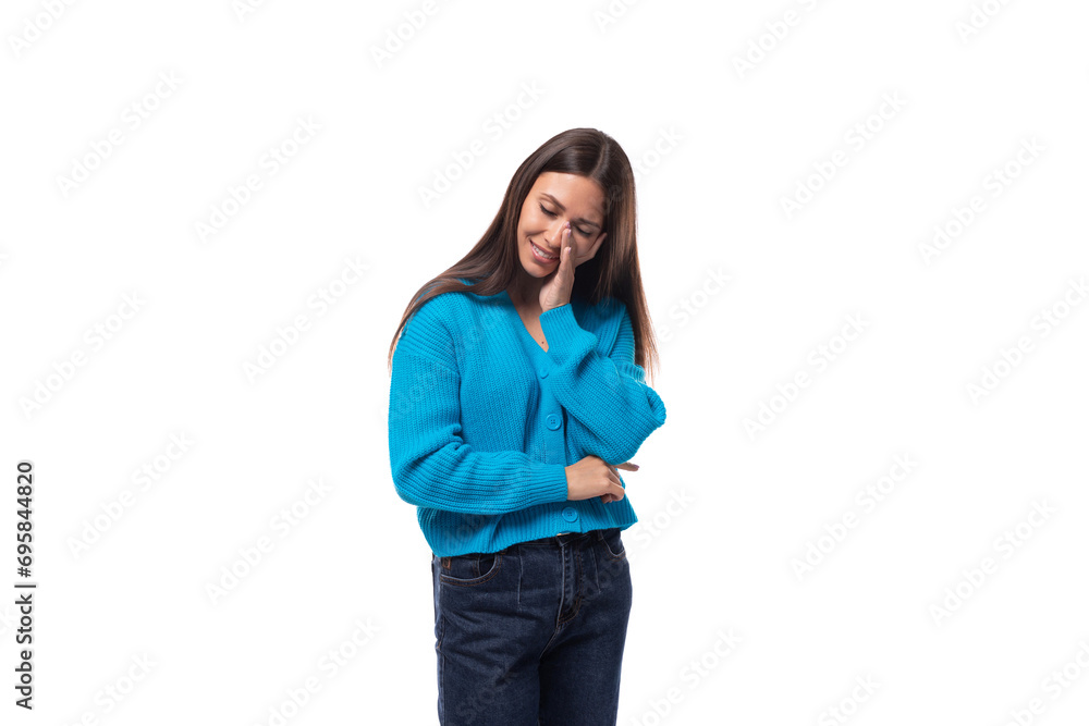 young pleasant slender brunette lady dressed in a blue jacket with a v-shaped on a white background with copy space. people lifestyle concept young pleasant slender brunette lady dressed in a blue jacket with a v-shaped on a white background with copy space. people lifestyle concept