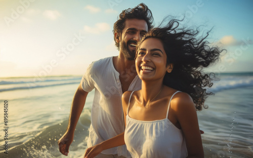 young indian couple enjoying at sea beach photo