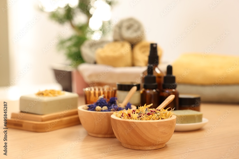 Dry flowers on wooden table indoors, space for text. Spa time Dry flowers on wooden table indoors, space for text. Spa time
