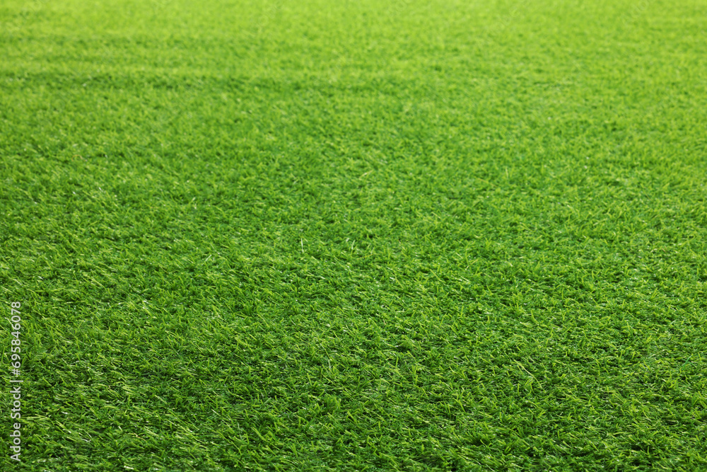 Green artificial grass as background, closeup view Green artificial grass as background, closeup view