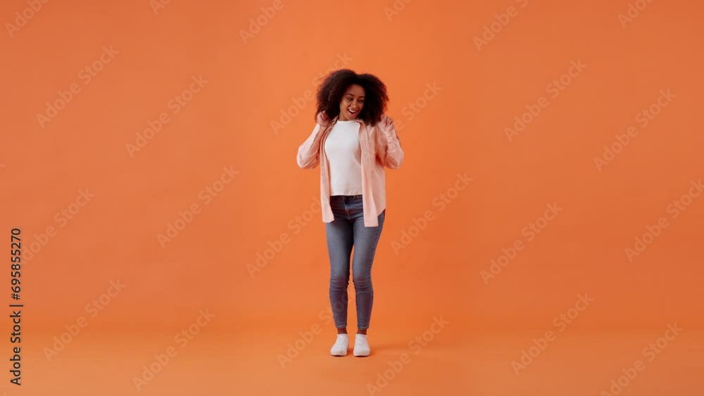 African American woman dances in place moving body in studio African American woman dances in place moving body in studio