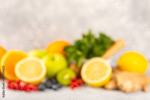 Oranges, apples, lemons, kiwi, mint, red currants and blueberries on a textured cement background. Fruits and berries. Vitamins for immunity. Place for text. Copy space.