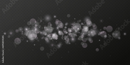 Dust light. Bokeh light lights effect background. Sparkling white particles. Christmas background from shining dust.