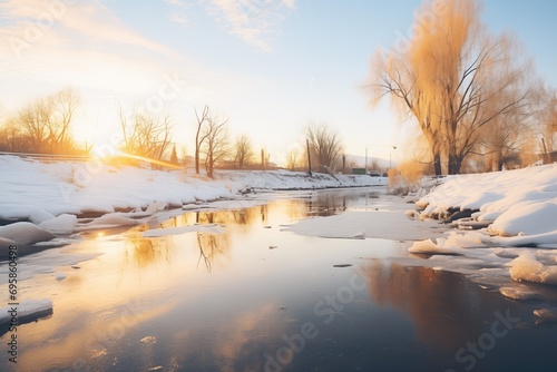 golden hour glow on a partially iced river © primopiano