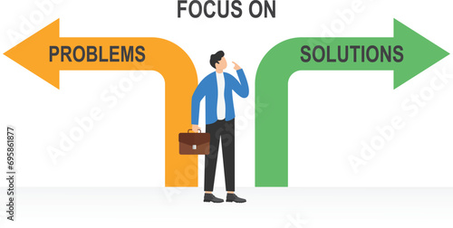 Focusing on solutions not on problems concept. Businessman standing at crossroad sign with the text

