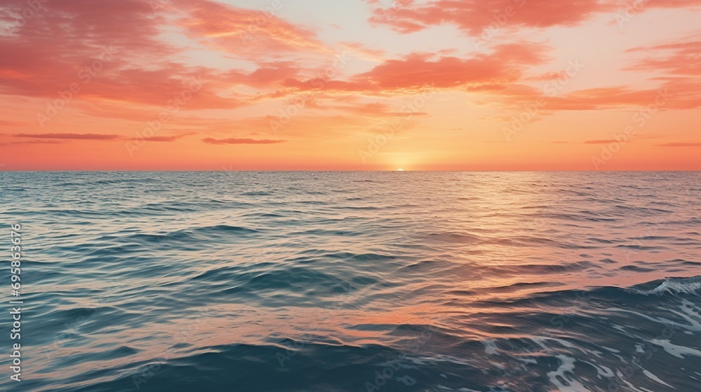 Scenic view of endless ocean with horizon line under bright sunset sky in evening time Scenic view of endless ocean with horizon line under bright sunset sky in evening time