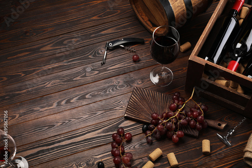 Winemaking. Composition with tasty wine and barrel on wooden table, above view. Space for text photo