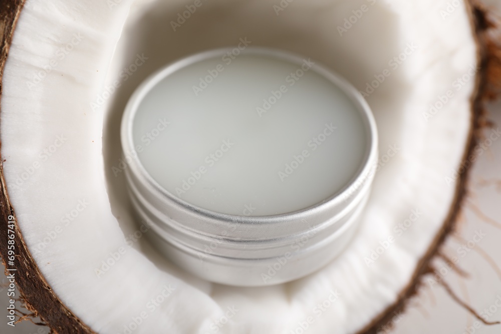Lip balm inside coconut on white background, closeup Lip balm inside coconut on white background, closeup