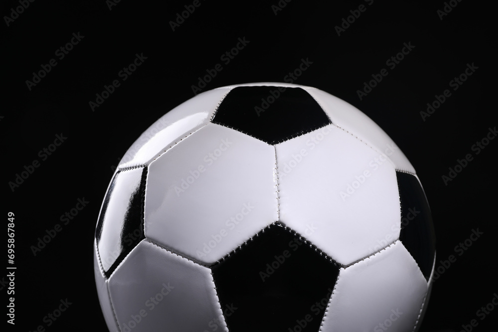One soccer ball on black background, closeup. Sports equipment