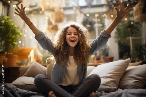 Exuberant Young Woman Celebrating Indoors.
Happy young woman with arms raised in a joyful expression indoors. photo