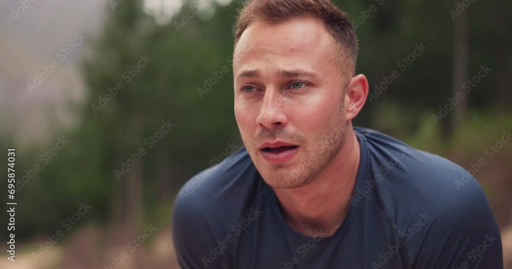 Tired man, runner and breathing in nature for training, workout and fitness goals, endurance and challenge. Young runner, athlete or sports person with fatigue, cardio exercise and break in forest Tired man, runner and breathing in nature for training, workout and fitness goals, endurance and challenge. Young runner, athlete or sports person with fatigue, cardio exercise and break in forest