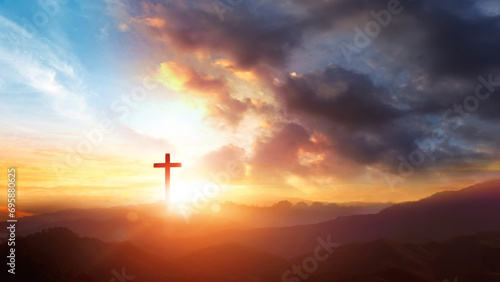 Cross of Jesus Christ on the background of the sunset sky with clouds