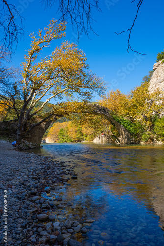 Fototapeta Naklejka Na Ścianę i Meble -  Beautiful view of Old Stone Bridge of the Klidonia an Autumn Day in in Zagorochoria., Greece.