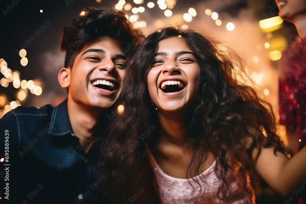 young Indian couple, are laughing and joyful dancing at party young Indian couple, are laughing and joyful dancing at party