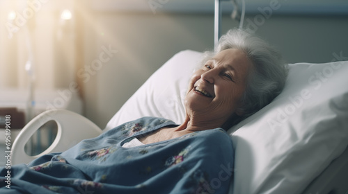 Smiling old woman in hospital bed, health insurance. Good care from the hospital. photo