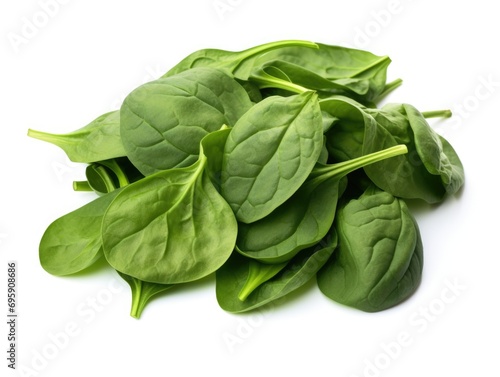 A pile of spinach leaves on a white surface.