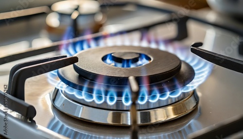 gas burning from a kitchen gas stove blue gas flame on hob closeup selective focus natural