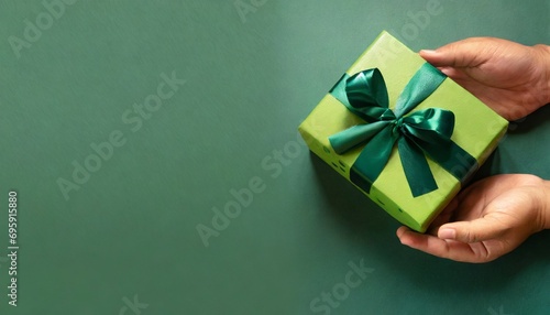 banner with green gift box with ribbon and bow for man and boy on green background holiday gift with birthday or christmas present flat lay top view father s day copy space generated by ai photo