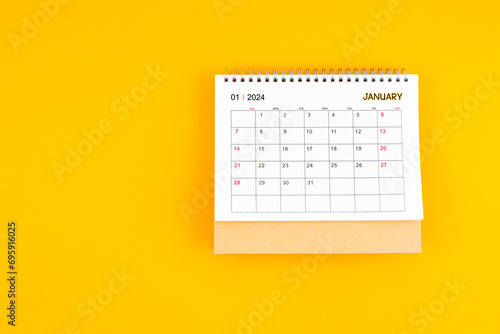January 2024 desk calendar on yellow color background, Position with copy space.