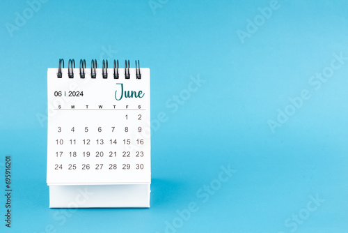 June 2024 mini desk calendar on blue color background.