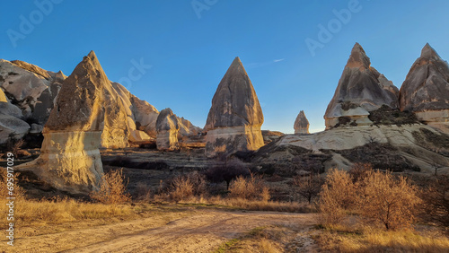 A diverse array of fairy chimneys punctuate the iconic Cappadocian landscape, each one telling a tale of time and geological wonder.