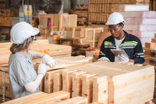 Engineer wearing safety vest controlling industrial machine working, talking with assistant worker checking first for labour with laptop computer, Officer setting a technology system in factory.