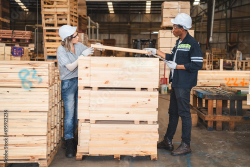 Engineer wearing safety vest controlling industrial machine working, talking with assistant worker checking first for labour with laptop computer, Officer setting a technology system in factory.