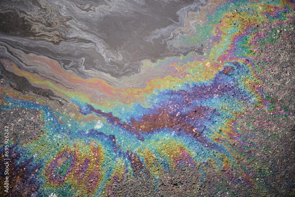 iridescent spot of gasoline on pavement. iridescent spot of gasoline on pavement.