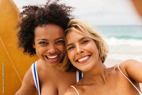 Happy female surfers capturing fun beach moments with a selfie © (JLco) Julia Amaral