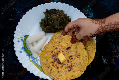 Makki Ki Roti , Sarson Ka Sag in white plate .  selective focus