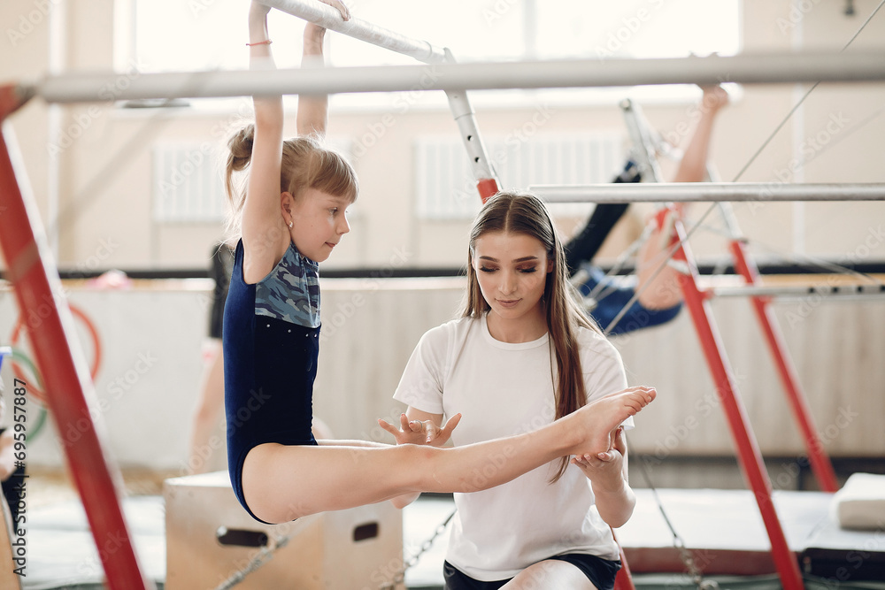 Prepare young child athlete gymnast on balance beam