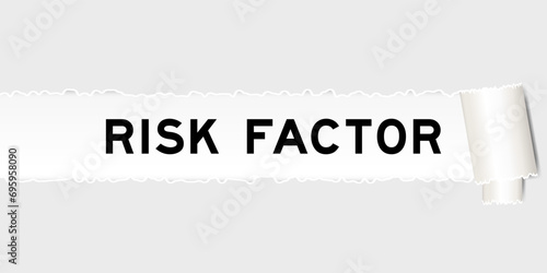 Ripped gray paper background that have word risk factor under torn part