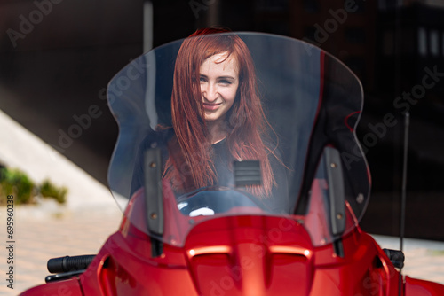 Red Motorcycle with Woman on Windshield. A red motorcycle with a picture of a woman on the windshield
