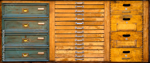 Three types of wooden fronts of old chest of drawers different in size, color and type of handles