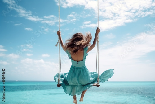 Maldivian Bliss. Attractive Woman Swinging Over Crystal Clear Waters © Bojan