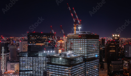 Photography aerial view on construction work on top of skyscrapers at night
